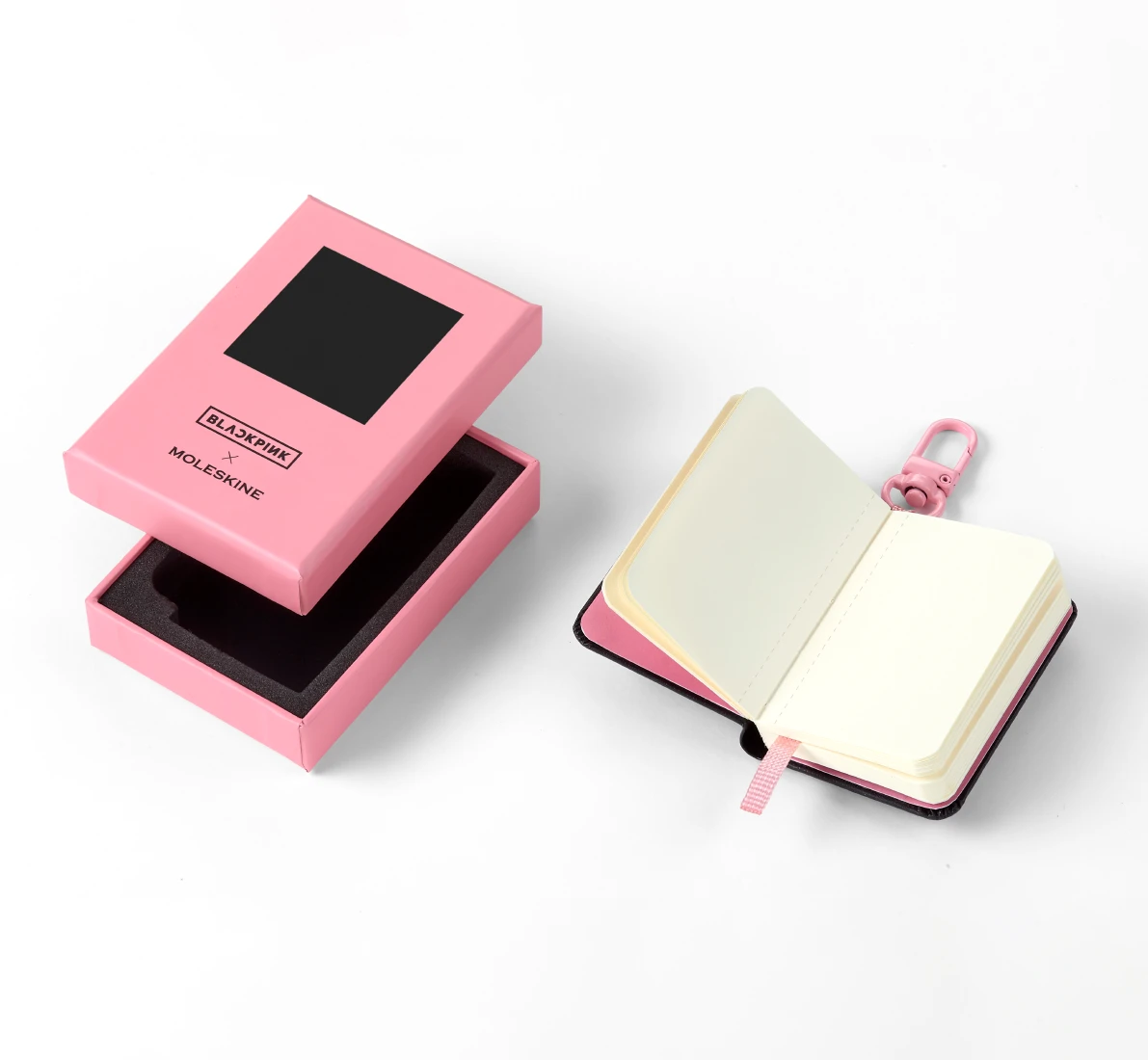 Moleskine x BLACKPINK notebook charm clipped onto a bag